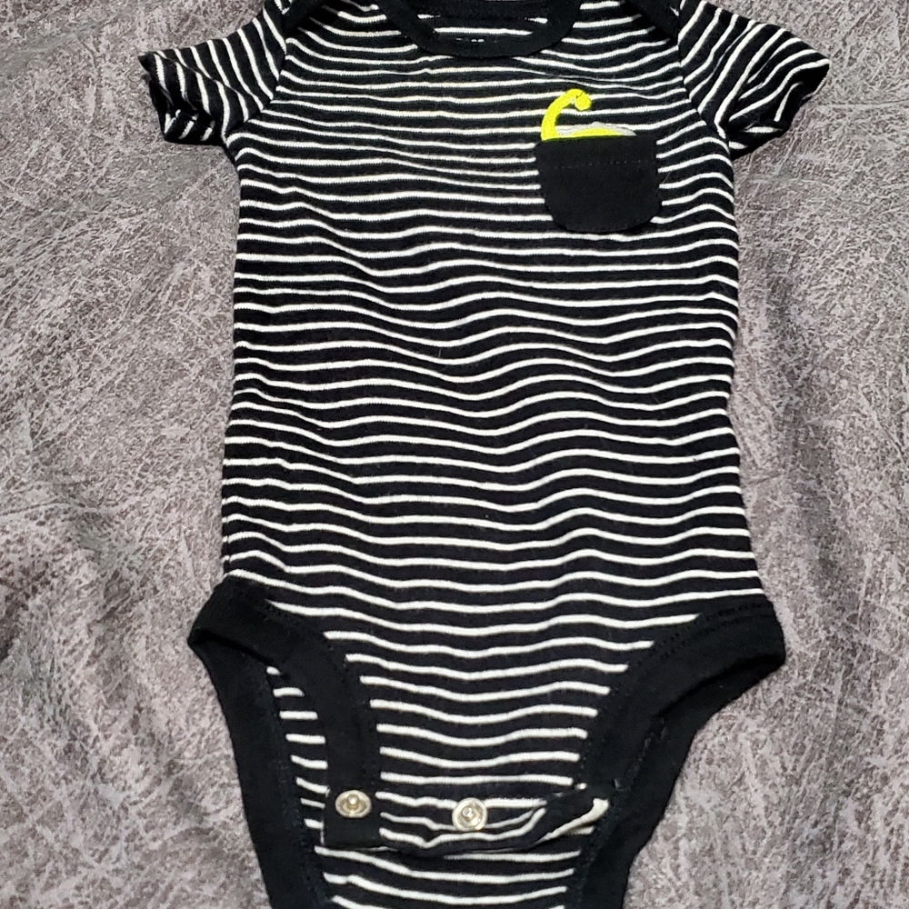 Cute striped onesie with dinosaur in pocket